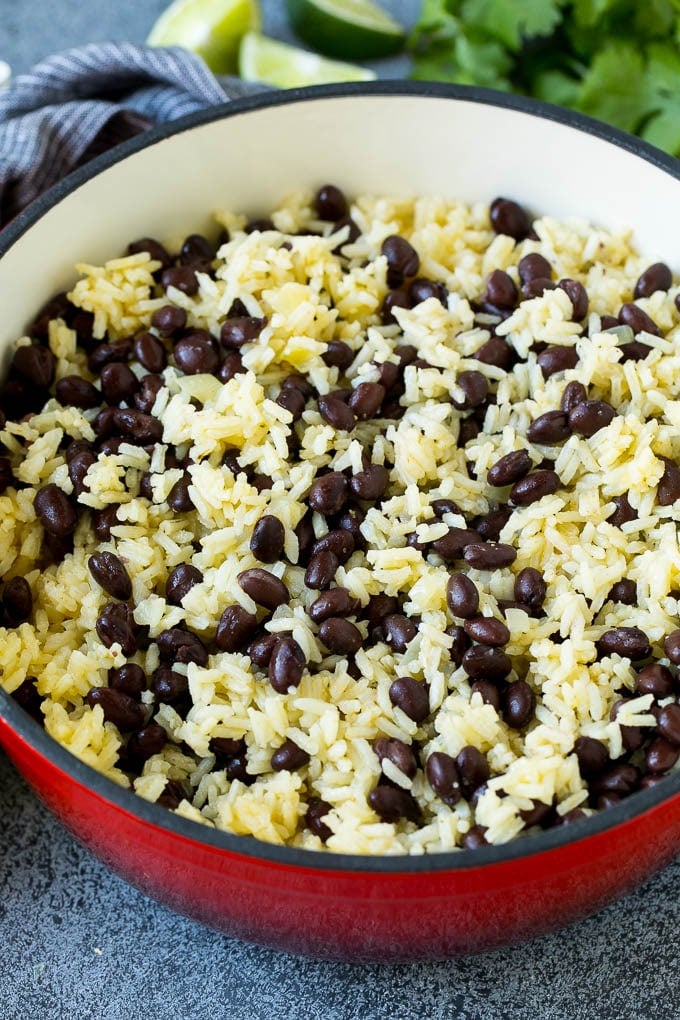 Black Beans and Rice Recipe | Cuban Black Beans | Beans and Rice #beans #rice #blackbeans #sidedish #glutenfree #dinner #edsug Rice and beans mixed together in a red pot.