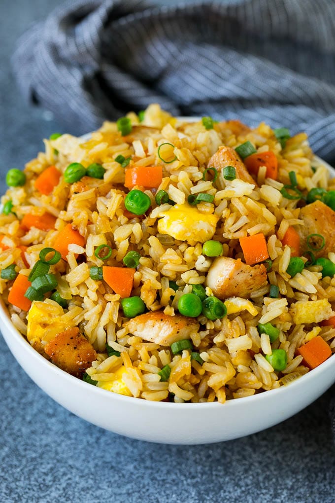 Chicken Fried Rice Recipe | Chinese Fried Rice #rice #chicken #peas #carrots #sidedish #dinner #edsug A bowl of chicken fried rice topped with sliced green onions.