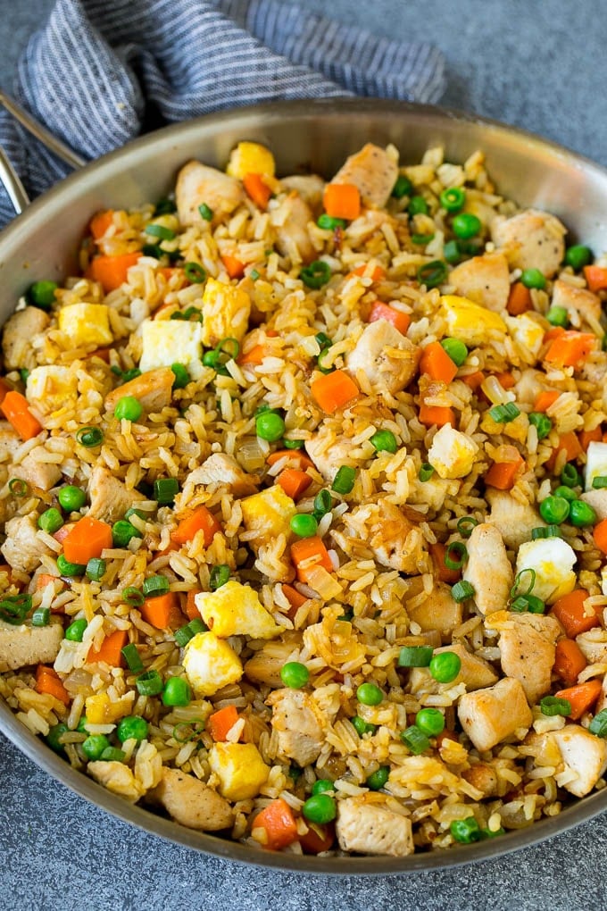 Chicken Fried Rice Recipe | Chinese Fried Rice #rice #chicken #peas #carrots #sidedish #dinner #edsug A pan of chicken fried rice with eggs and vegetables.