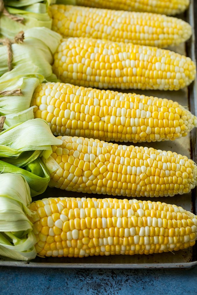 Grilled Corn on the Cob Recipe | Corn Recipe #corn #grilling #summer #sidedish #dinner #edsug Corn cobs on a sheet pan.