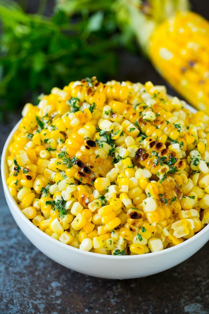 Grilled Corn on the Cob Recipe | Corn Recipe #corn #grilling #summer #sidedish #dinner #edsug Grilled corn cut off the cob with herb butter in a bowl.