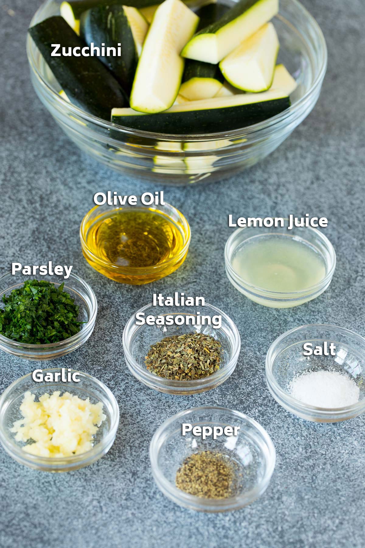 Bowls of ingredients including olive oil, lemon juice, herbs and spices.