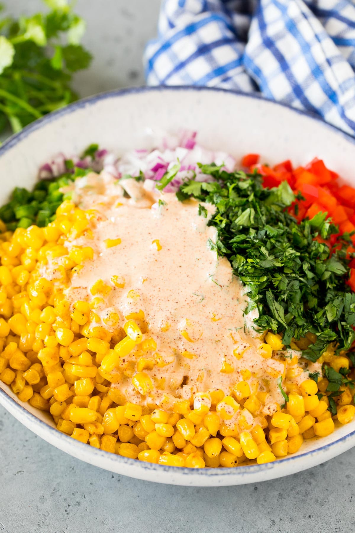 Dressing poured over a bowl of vegetables.