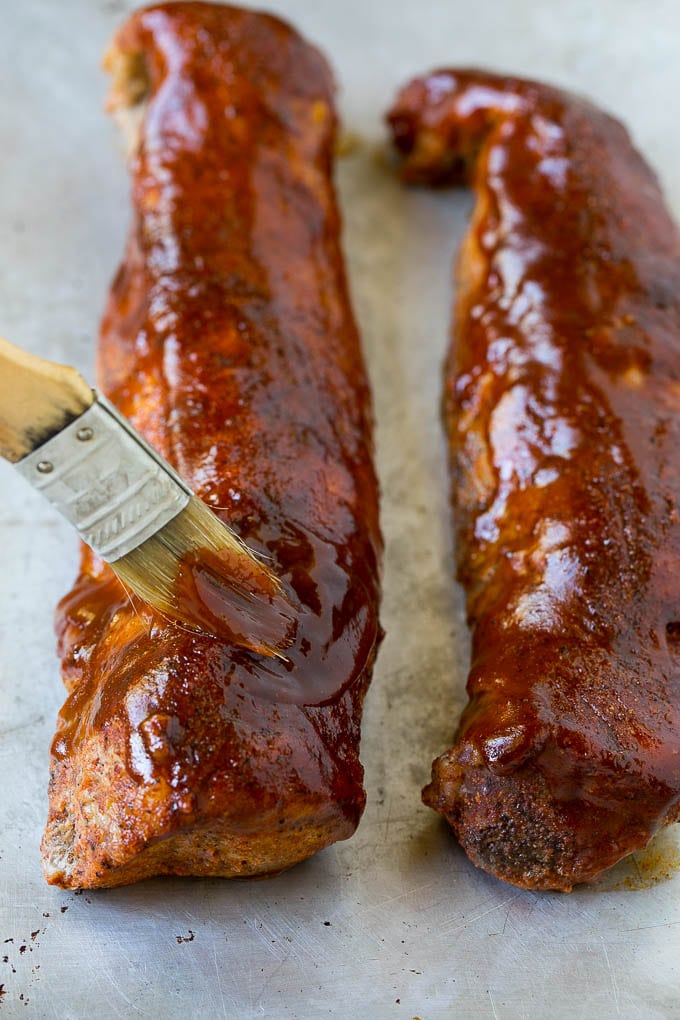 Smoked Pork Tenderloin Recipe | Smoked Pork Loin | BBQ Pork #pork #tenderloin #smoker #dinner #edsug BBQ sauce being brushed over smoked pork loin.