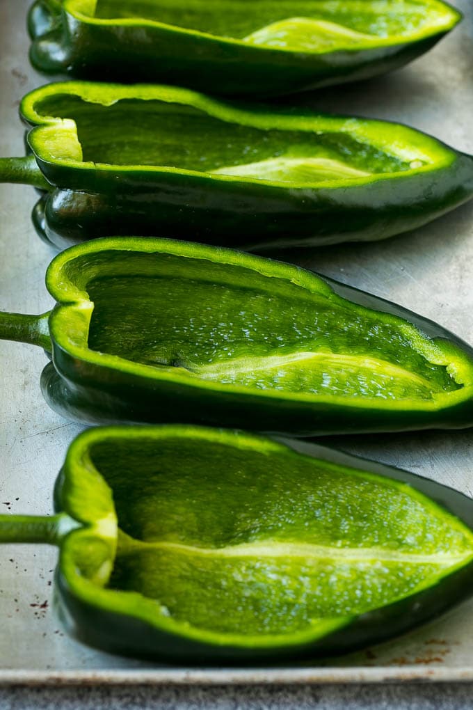 Stuffed Poblano Peppers | Stuffed Peppers | Pasilla Peppers #peppers #stuffedpeppers #beef #rice #beans #corn #dinner #edsug Hollowed out poblano peppers on a pan.