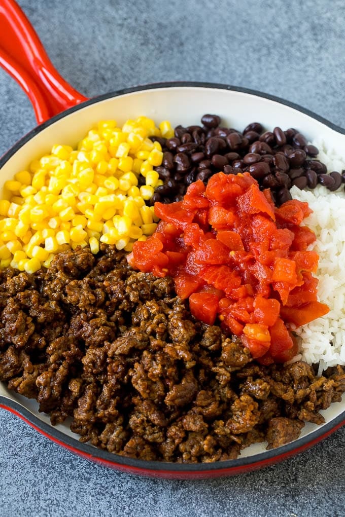 Stuffed Poblano Peppers | Stuffed Peppers | Pasilla Peppers #peppers #stuffedpeppers #beef #rice #beans #corn #dinner #edsug A skillet filled with ground beef, rice, tomatoes, beans and corn.