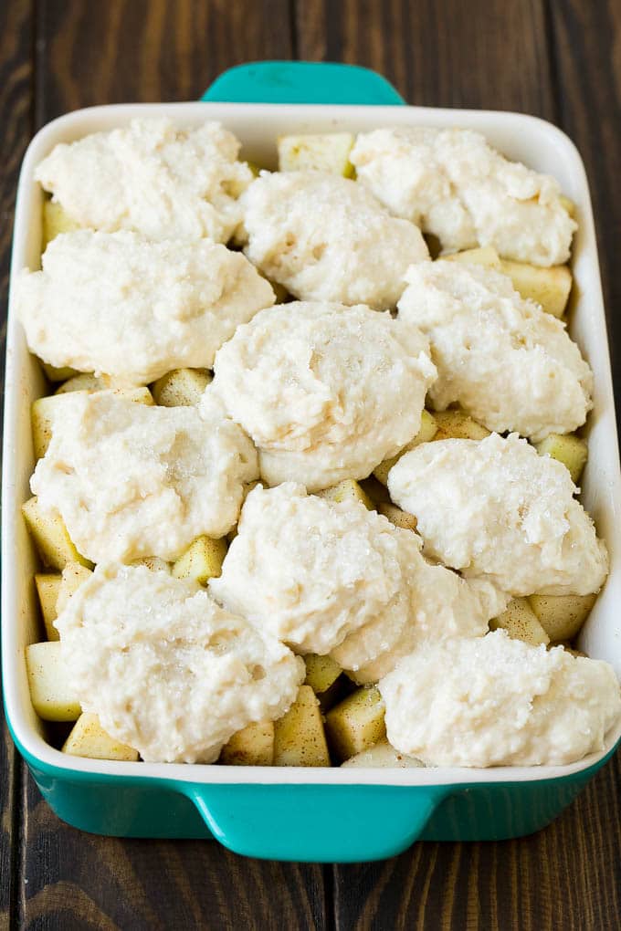 Apple Cobbler Recipe | Apple Dessert #apples #cobbler #dessert #baking #fall #edsug Fruit in a baking dish with dough over the top.