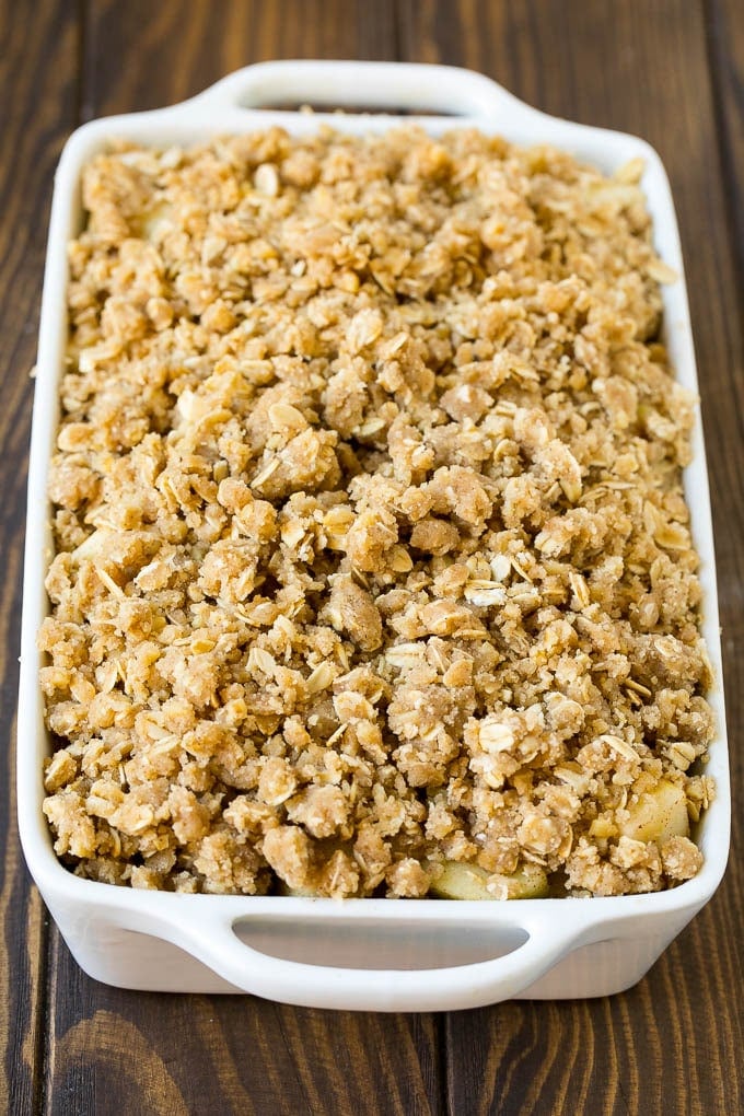Apple Crisp Recipe | Apple Dessert #apples #dessert #baking #fall #edsug Apples in a baking dish topped with brown sugar crumble.