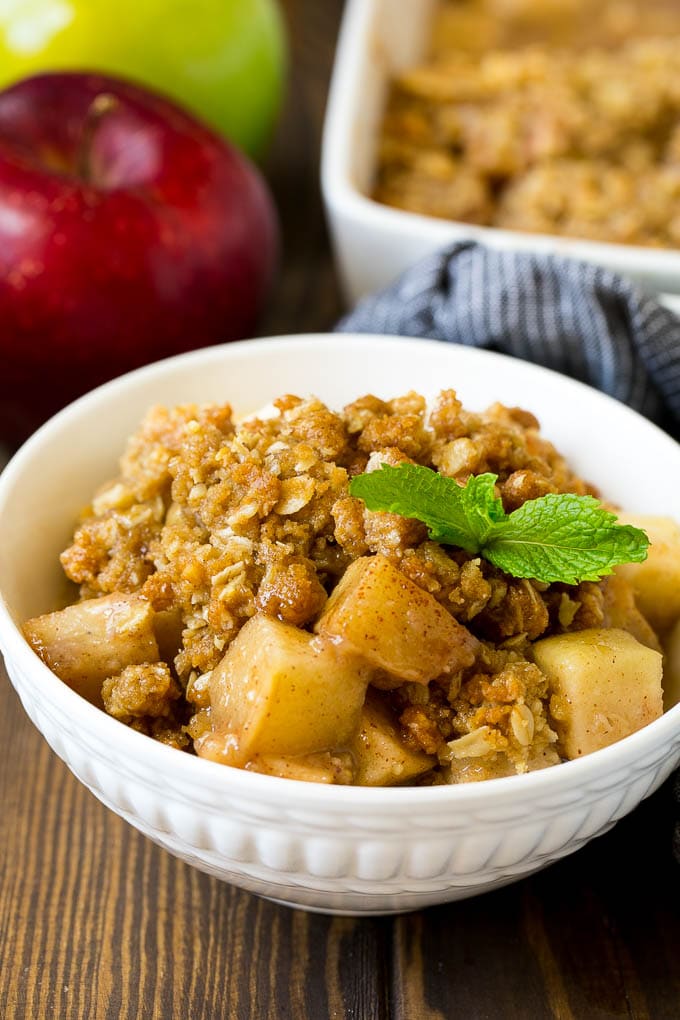 Apple Crisp Recipe | Apple Dessert #apples #dessert #baking #fall #edsug A bowl of apple crisp garnished with a sprig of mint.