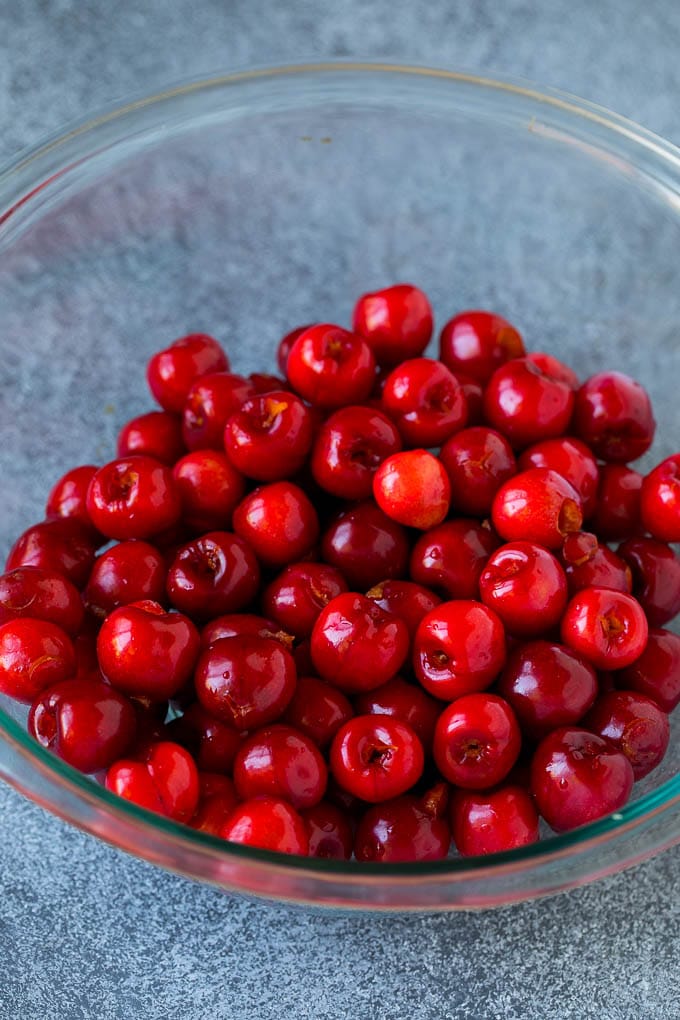 Cherry Pie Filling Recipe #pie #cherries #dessert #sweets #edsug #summer A bowl of pitted cherries.