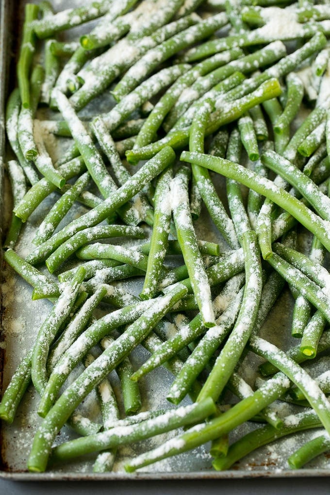 Fried Green Beans Recipe | Green Beans #greenbeans #appetizer #snack #edsug Bean coated in flour on a pan.