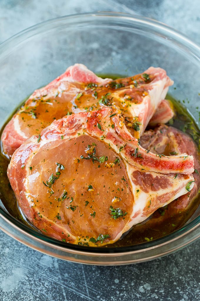 Grilled Pork Chops | Pork Chop Marinade #porkchops #grilling #pork #marinade #dinner #edsug Pork chops in a bowl of marinade.