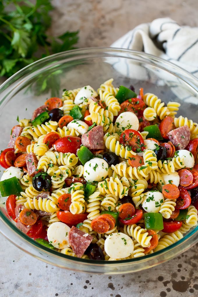 Italian Pasta Salad | Pasta Salad Recipe #pasta #salad #pastasalad #pepperoni #salami #olives #cheese #sidedish #edsug A bowl of Italian pasta salad filled with meats, cheese and vegetables.