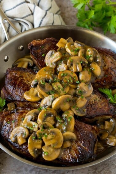 Mushroom steak sauce served over New York strip steaks.