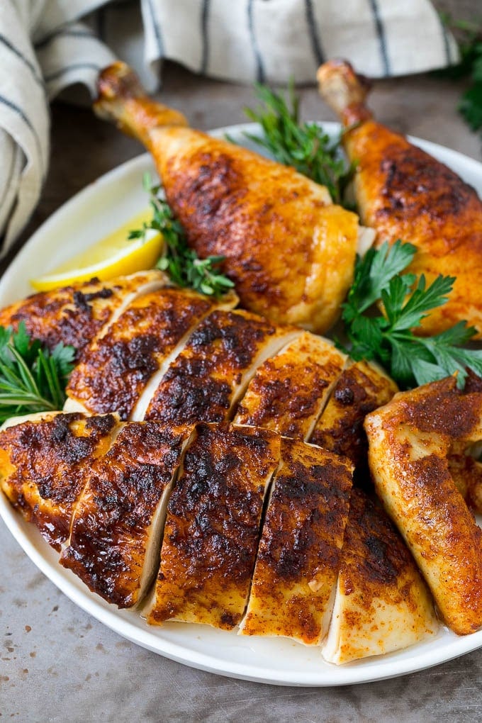 Rotisserie Chicken Recipe | Roasted Chicken #chicken #dinner #edsug #comfortfood Sliced roasted chicken on a serving plate.