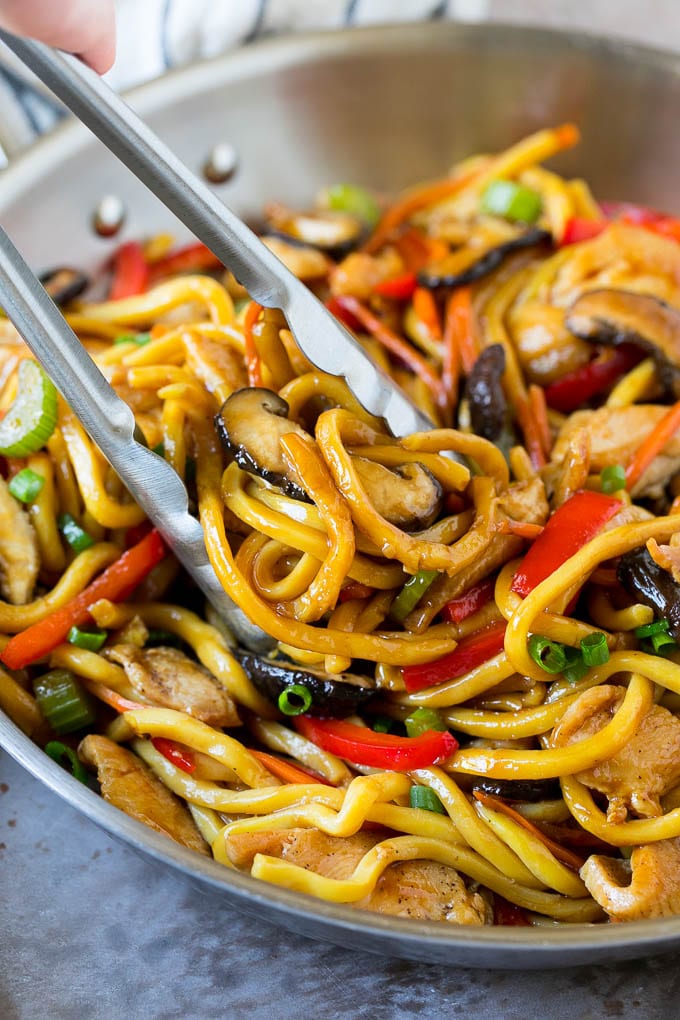Stir Fry Noodles Recipe | Noodle Stir Fry #chicken #noodles #stirfry #mushrooms #dinner #edsug Tongs serving up a portion of chicken and noodle stir fry.