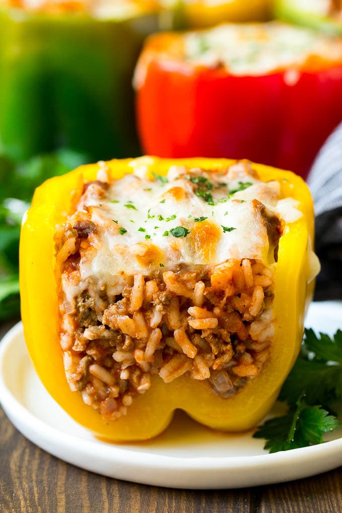 Stuffed Bell Peppers Recipe | Stuffed Peppers #beef #rice #peppers #dinner #cheese #edsug A stuffed bell pepper cut open on a plate.