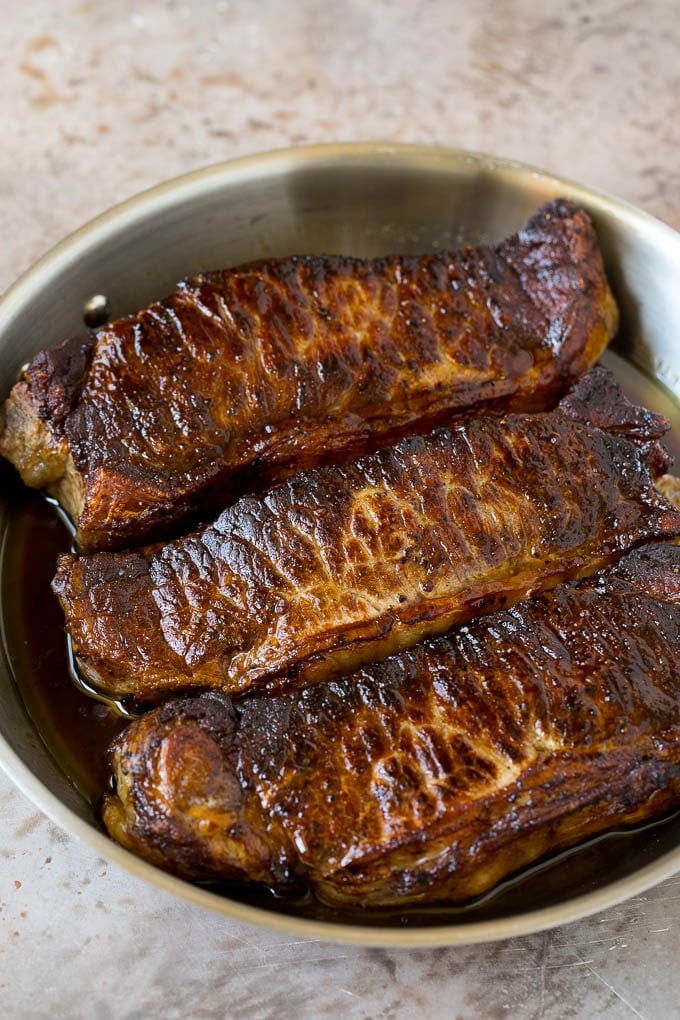 Surf and Turf Recipe | Seared Steak #steak #shrimp #keto #lowcarb #dinner #edsug Seared strip steaks in a skillet.