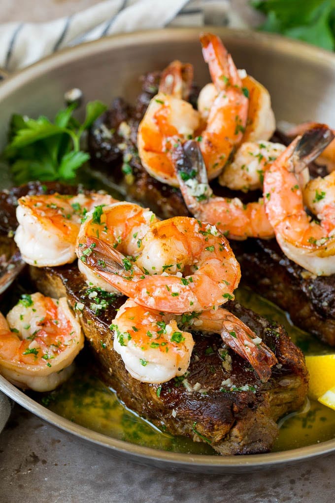 Surf and Turf Recipe | Seared Steak #steak #shrimp #keto #lowcarb #dinner #edsug Surf and turf with seared strip steaks topped with jumbo shrimp in garlic butter.