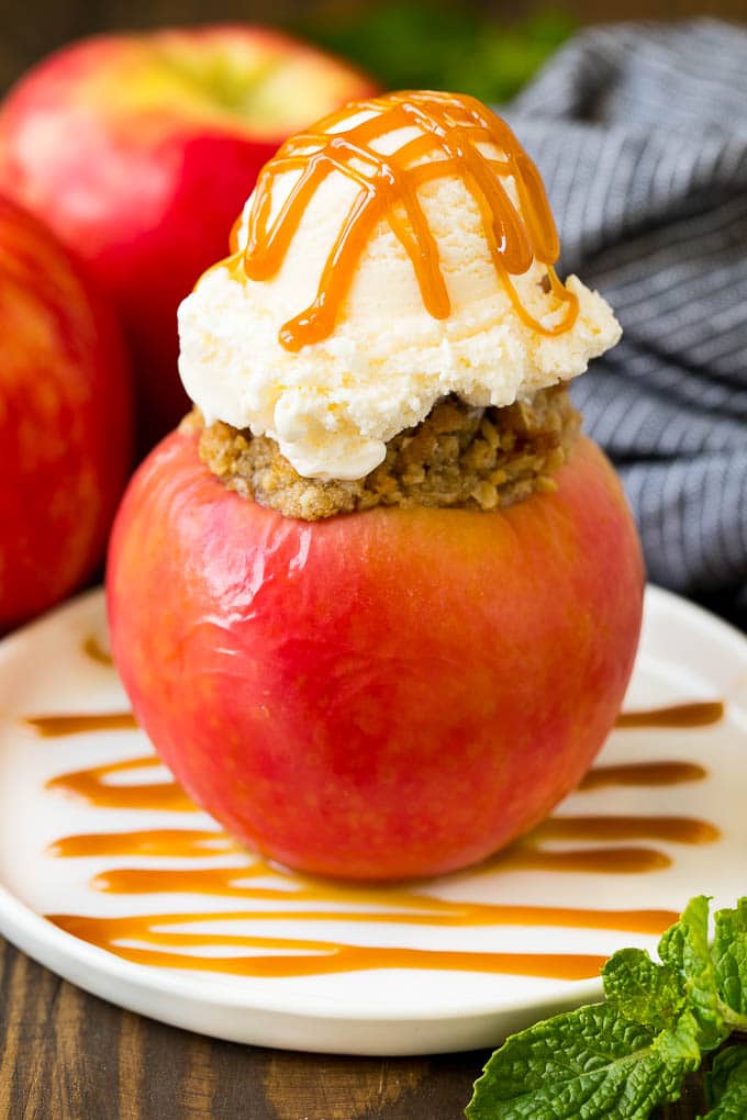 Baked Apples | Stuffed Apples #apples #fall #dessert #sweettooth #edsug A baked apple topped with vanilla ice cream and caramel sauce.