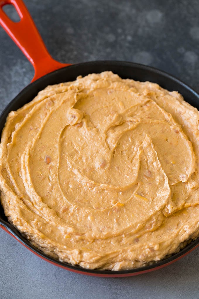 Bean Dip Recipe | Mexican Dip #dip #appetizer #mexicanfood #beans #cheese #edsug Refried frijoles mixed with cream cheese, sour cream and seasonings in a skillet.