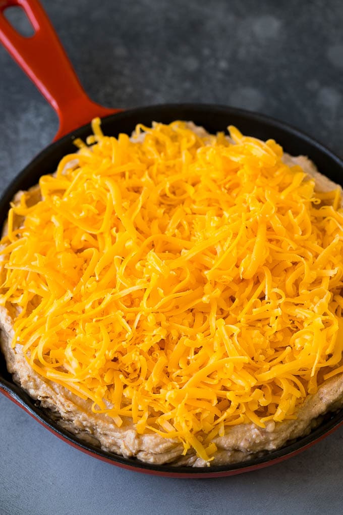 Bean Dip Recipe | Mexican Dip #dip #appetizer #mexicanfood #beans #cheese #edsug The base topped with freshly shredded cheese.
