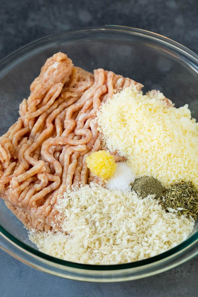 Chicken Meatballs Recipe | Baked Meatballs #chicken #meatballs #dinner #edsug #comfortfood Ground chicken, herbs, breadcrumbs and cheese in a mixing bowl.
