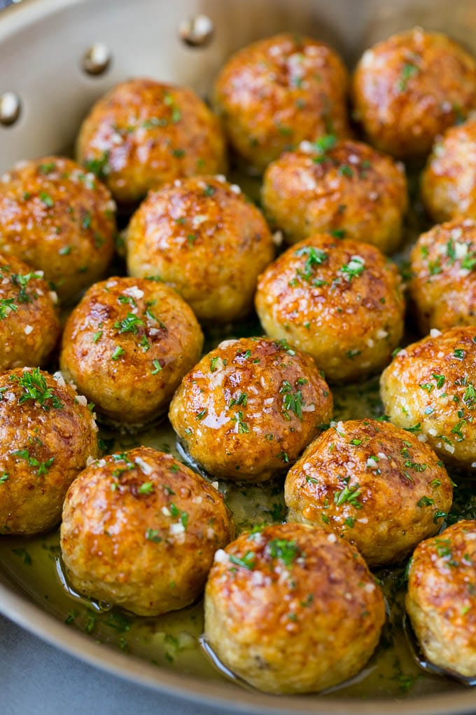 Chicken Meatballs Recipe | Baked Meatballs #chicken #meatballs #dinner #edsug #comfortfood Chicken meatballs in a skillet of garlic butter.