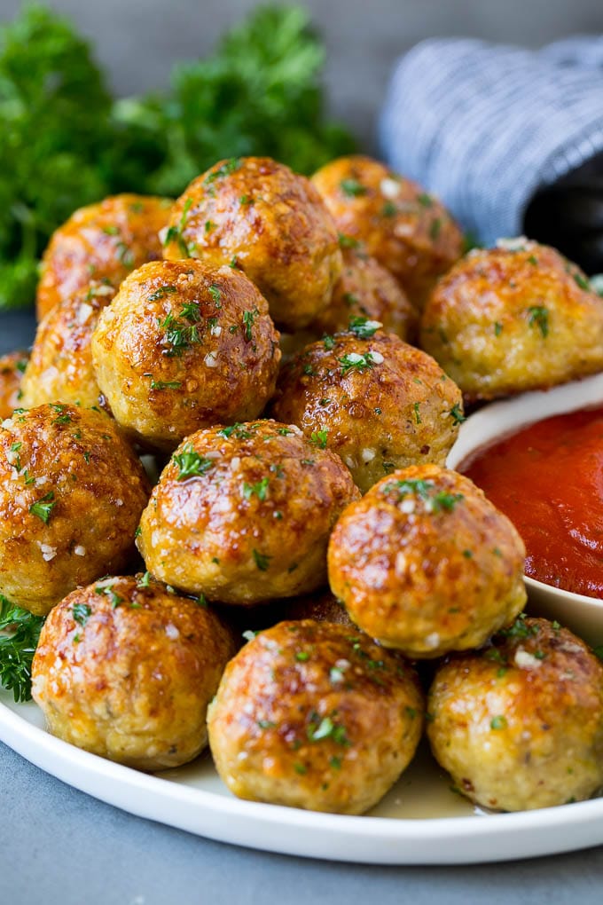 Chicken Meatballs Recipe | Baked Meatballs #chicken #meatballs #dinner #edsug #comfortfood A serving plate of chicken meatballs served with marinara sauce.