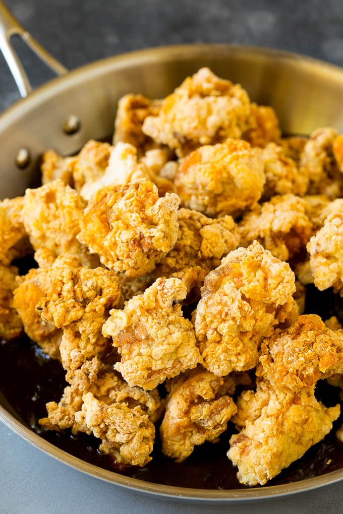 General Tso's Chicken Recipe #chicken #asianfood #dinner #edsug #copycatrecipe Crispy chicken in a skillet filled with savory and spicy sauce.