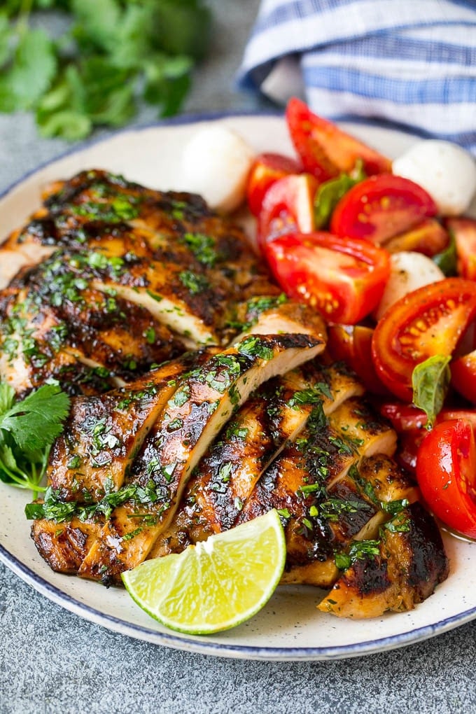Grilled Chicken Thighs Recipe | Marinated Chicken Thighs #chicken #grilling #marinade #dinner #cilantro #lime #edsug Sliced chicken thighs served with tomato salad.