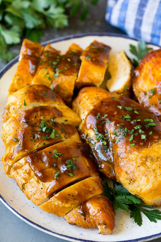 Slow Cooker Chicken Breast Recipe | Crock Pot Chicken Breast | Chicken and Gravy #chicken #slowcooker #crockpot #gravy #dinner #edsug Sliced crock pot chicken breasts on a serving plate.