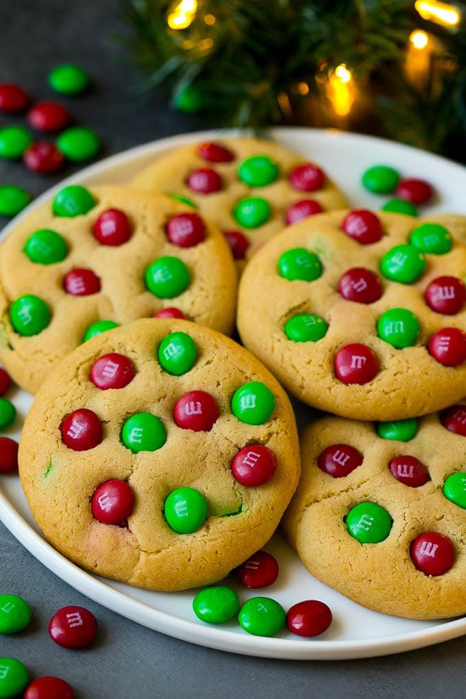 M&M Cookies Recipe #cookies #chocolate #baking #dessert #sweets #edsug A plate of Christmas cookies with red and green M&Ms in them.