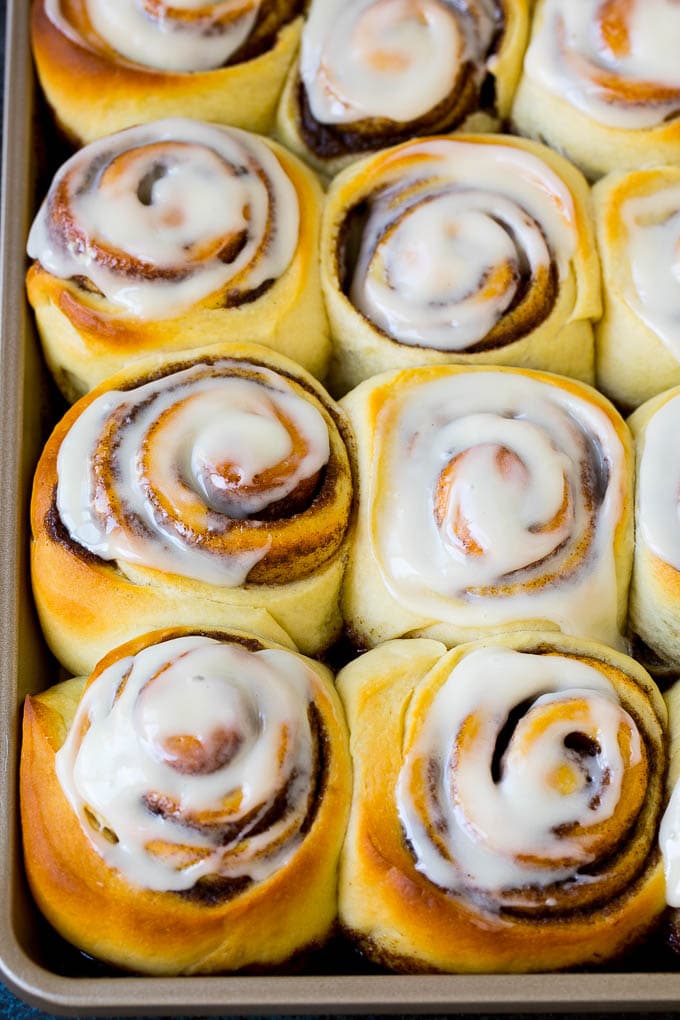 Cinnamon Rolls Recipe | Cinnamon Buns #cinnamon #rolls #pastry #breakfast #brunch #sweets #edsug #baking #bread A tray of frosted cinnamon rolls.