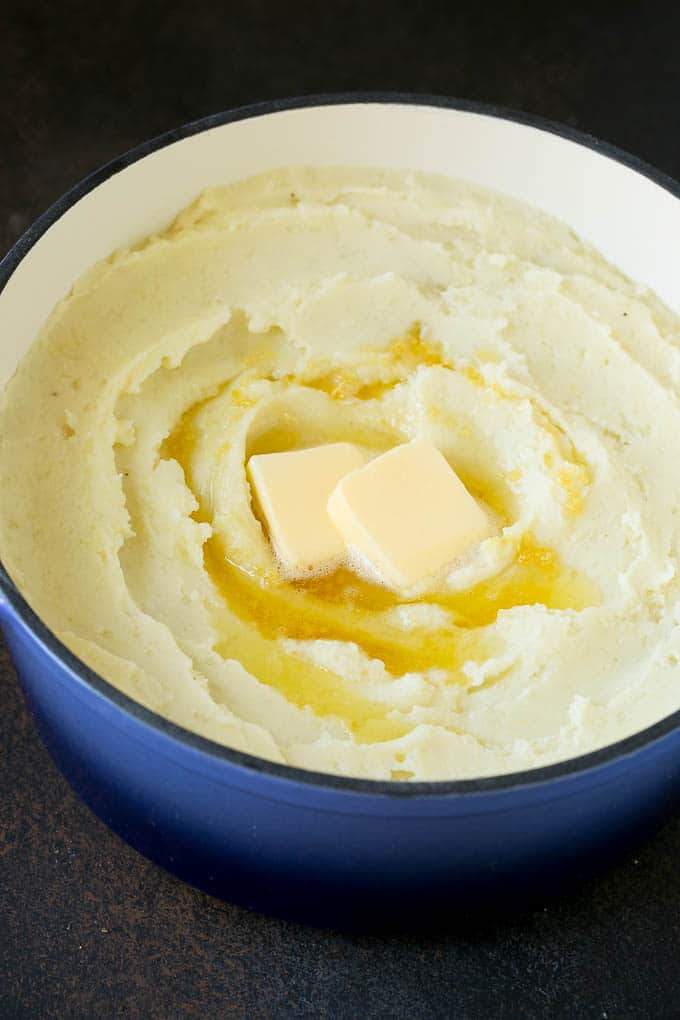 Garlic Mashed Potatoes Recipe #garlic #potatoes #mashedpotatoes #sidedish #dinner #thanksgiving #edsug Spuds with melted butter on top.