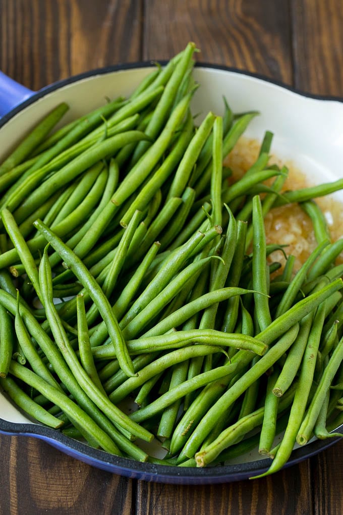 Green Beans with Bacon Recipe | Bacon Green Beans #bacon #greenbeans #sidedish #thanksgiving #veggies #dinner #edsug Beans in a pan with onions.