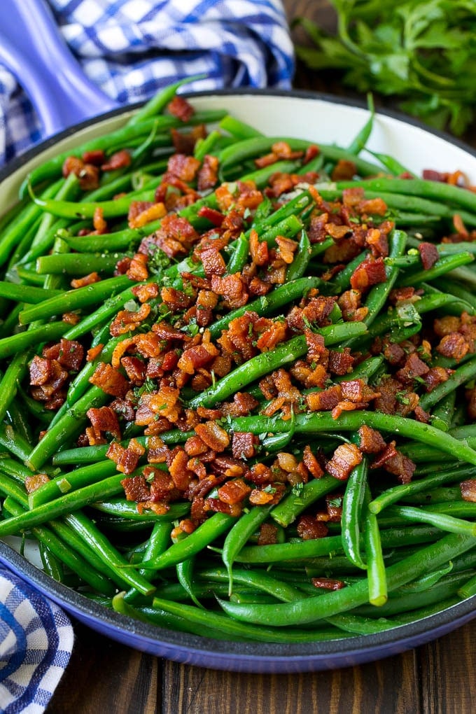 Green Beans with Bacon Recipe | Bacon Green Beans #bacon #greenbeans #sidedish #thanksgiving #veggies #dinner #edsug Green beans with bacon in a skillet, topped with parsley.