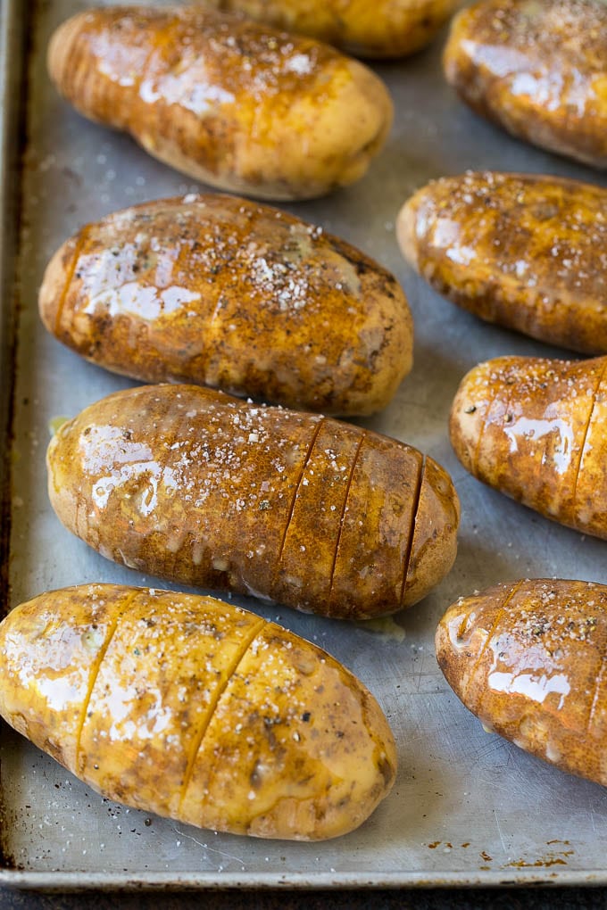 Hasselback Potatoes Recipe #potatoes #bacon #sidedish #cheese #dinner #edsug Potatoes on a sheet pan coated in olive oil and butter.