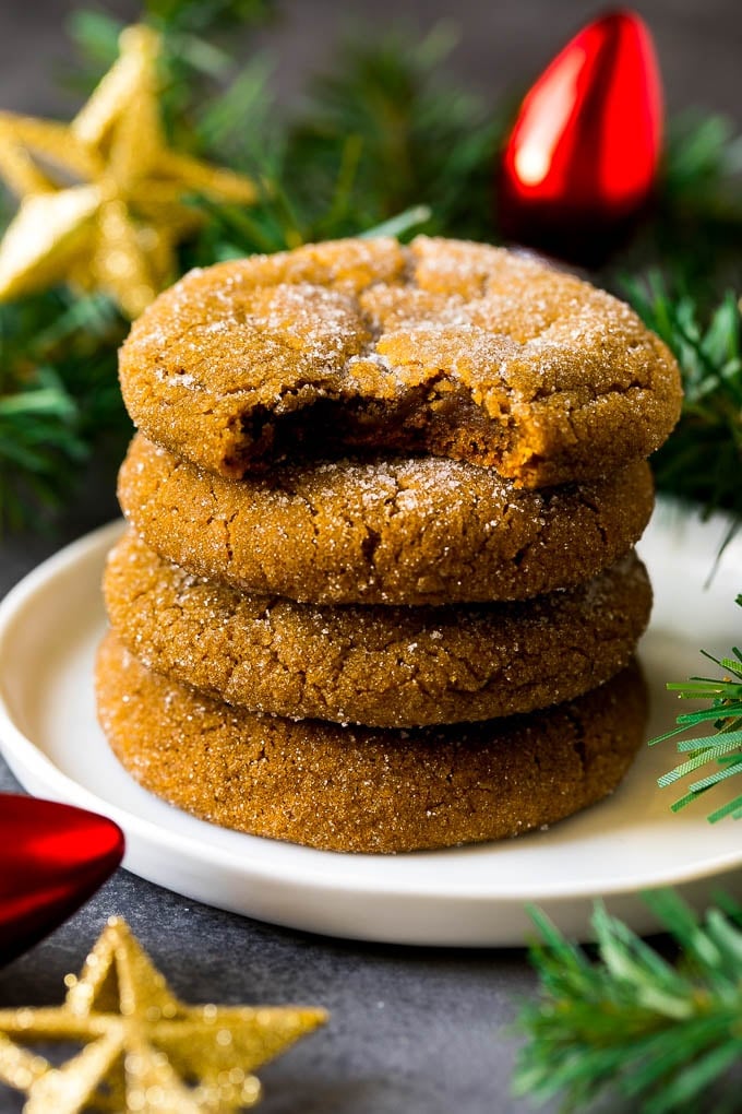 Molasses Cookies Recipe | Spice Cookies #cookies #baking #christmas #dessert #edsug A stack of molasses cookies with a bite taken out of one.