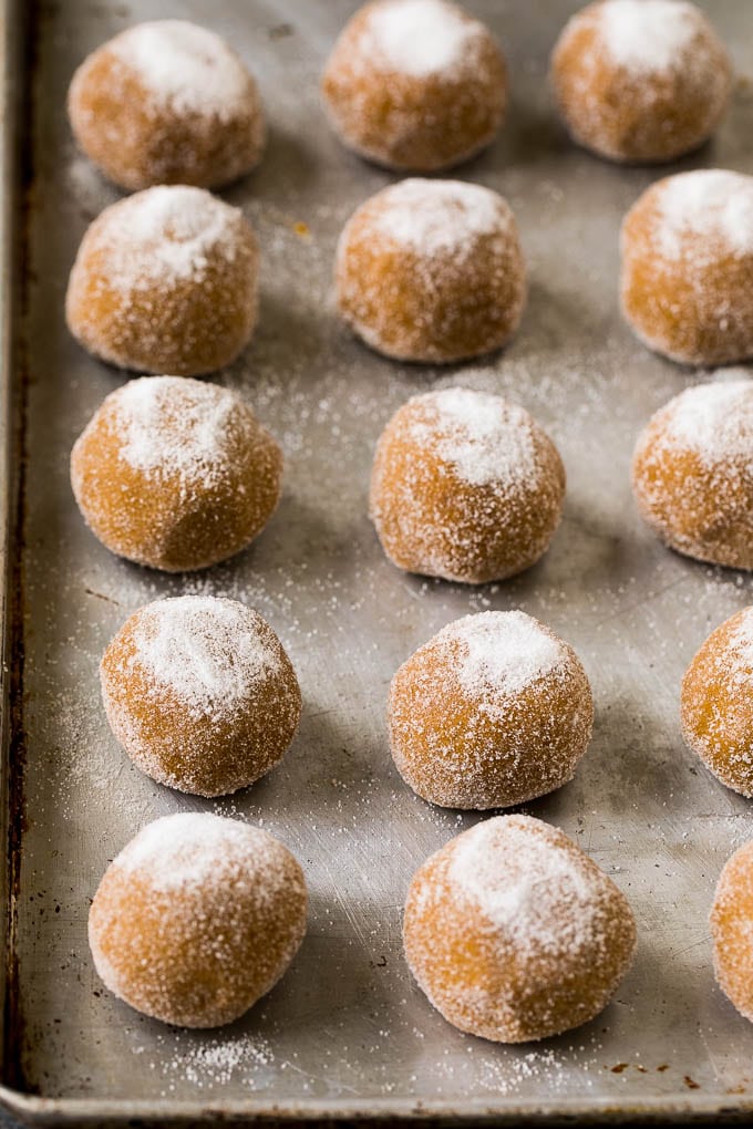 Molasses Cookies Recipe | Spice Cookies #cookies #baking #christmas #dessert #edsug Balls of cookie dough rolled in sugar on a sheet pan.