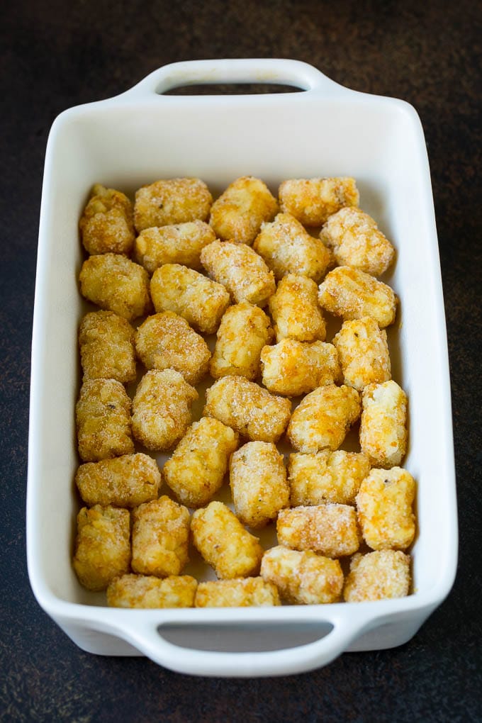 Sausage Egg Casserole Recipe | Egg Casserole #eggs #sausage #potato #cheese #casserole #breakfast #brunch #edsug Potato tots in a casserole dish.