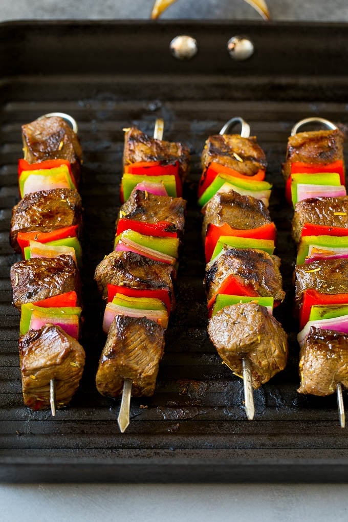 Beef Shish Kabobs Recipe | Beef Kabobs #grilling #beef #steak #dinner #edsug #peppers Beef skewers cooking on a grill pan.