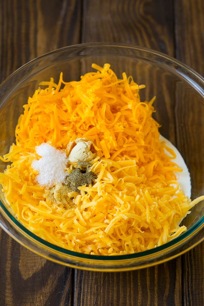 Southern Mac and Cheese | Baked Macaroni and Cheese #pasta #macandcheese #dinner #comfortfood #cheese #edsug A bowl of milk, cream, two types of shredded cheese and seasonings.