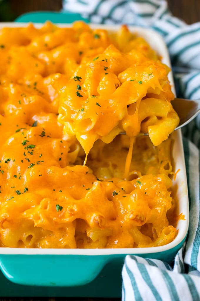 Southern Mac and Cheese | Baked Macaroni and Cheese #pasta #macandcheese #dinner #comfortfood #cheese #edsug A spoon serving up a portion of Southern mac and cheese.