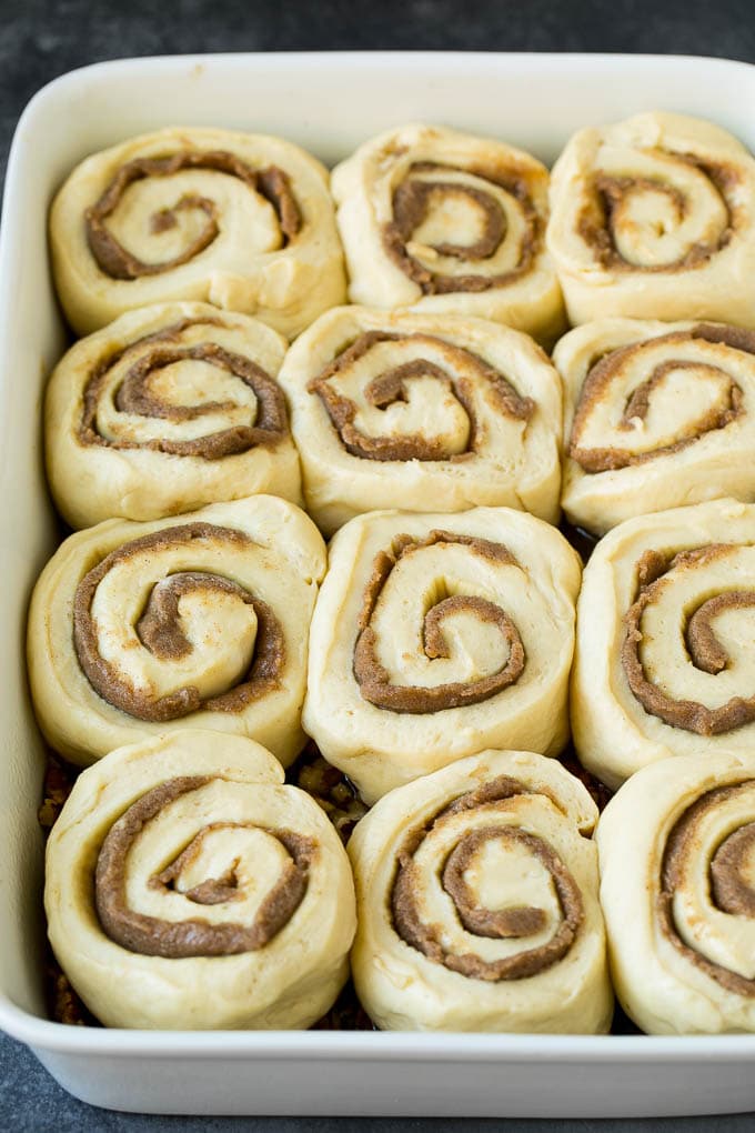 Sticky Buns Recipe | Sweet Rolls | Cinnamon Rolls #breakfast #brunch #cinnamon #pecans #edsug #bread Cinnamon swirl dough in a baking dish.