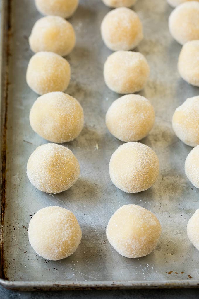 Thumbprint Cookies | Sugar Cookies #cookies #baking #christmas #dessert #edsug Balls of cookie dough rolled in sugar.