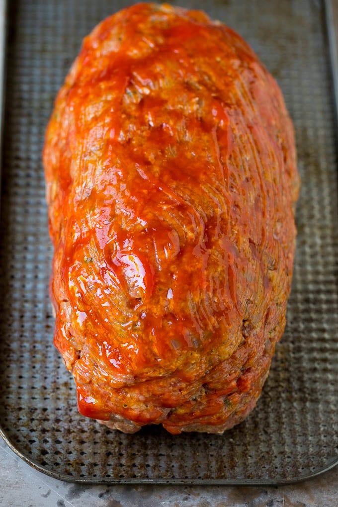 Bacon Wrapped Meatloaf Recipe | Beef Meatloaf #meatloaf #beef #groundbeef #bacon #dinner #edsug Ground beef shaped into a loaf and coated in ketchup.