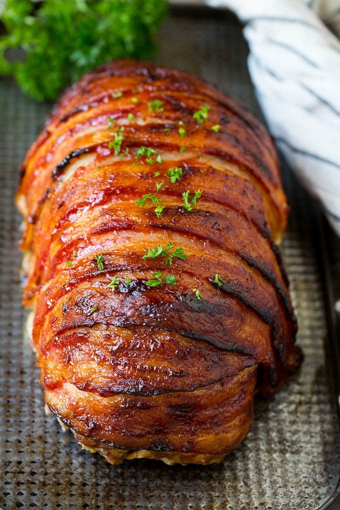 Bacon Wrapped Meatloaf Recipe | Beef Meatloaf #meatloaf #beef #groundbeef #bacon #dinner #edsug Meatloaf wrapped in slices of bacon and baked, then topped with parsley.