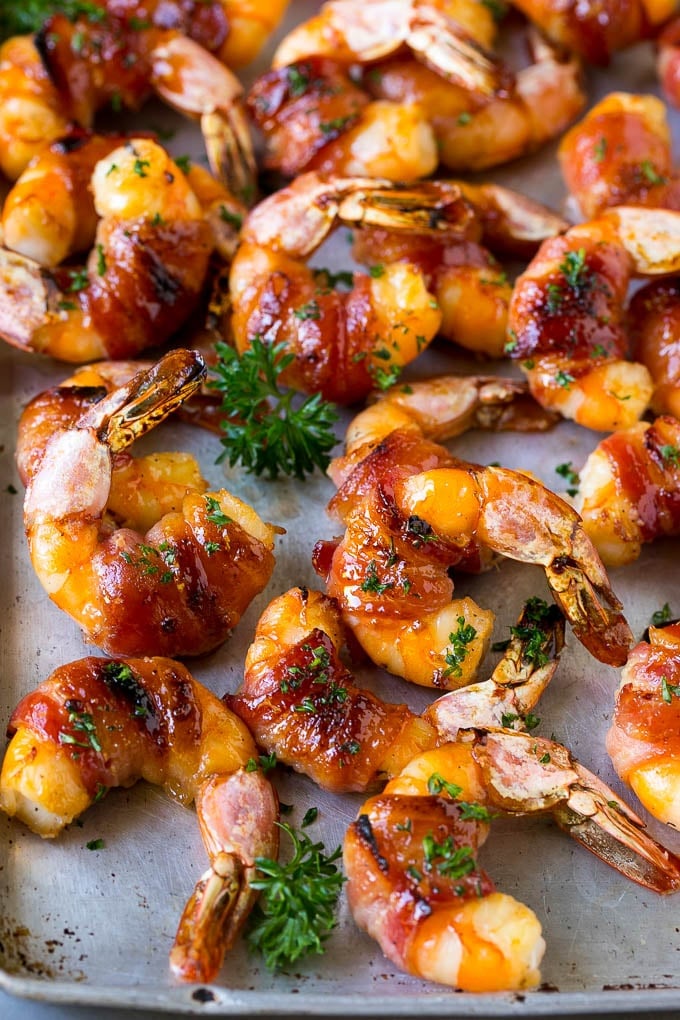 Bacon Wrapped Shrimp Recipe | Bacon Shrimp #shrimp #bacon #appetizer #dinner #edsug #seafood Bacon wrapped shrimp in a sweet and savory glaze, garnished with parsley.