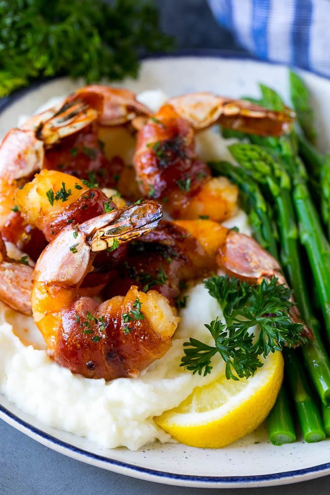 Bacon Wrapped Shrimp Recipe | Bacon Shrimp #shrimp #bacon #appetizer #dinner #edsug #seafood Bacon wrapped shrimp served over mashed potatoes with green beans.